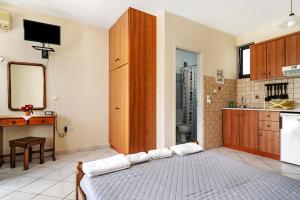 a kitchen with a large bed in a room at Daratos studio 4 in Kefallonia +12 photos