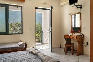 a bedroom with a bed and a desk and a mirror at Daratos studio 4 in Kefallonia