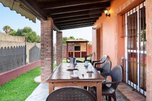 a wooden table and chairs on a patio at Casa Juana Zahora in Zahora