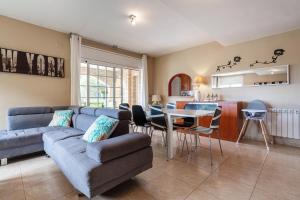 a living room with a couch and a table at Villa Yulia in Vidreres