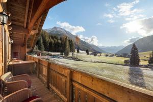 a balcony with chairs and a view of a mountain at Burgerhof in Gsies