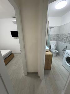 a bathroom with a toilet and a sink and a mirror at Appartamenti Flora in Castelsardo +42 photos