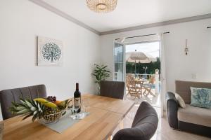 a dining room with a table with a bottle of wine at Villa Martina in Albufeira