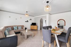 a living room with a couch and a table at Villa Martina in Albufeira