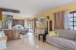 a bedroom with a bed and a couch in a room at Lemon Green in Celle Ligure