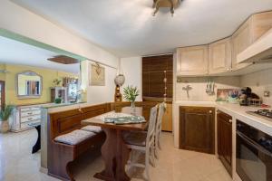 a kitchen with a wooden table and a table and a counter at Lemon Green in Celle Ligure +29 photos