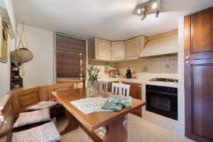 a kitchen with wooden cabinets and a wooden table at Lemon Green in Celle Ligure