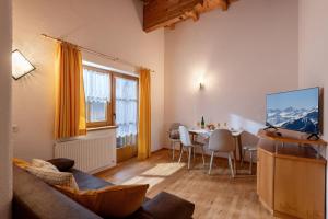 a living room with a table and a dining room at Zeunerhof in Fügen