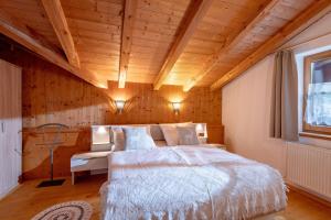 a bedroom with a bed and a wooden ceiling at Zeunerhof in Fügen
