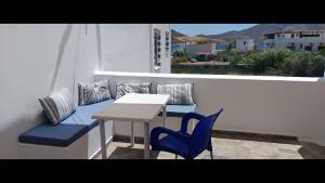 a table and chairs sitting on a balcony with a table and chairs at Pico Bello Patmos 28 in Patmos