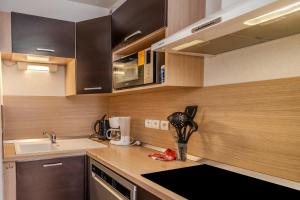 a kitchen with a sink and a counter top at Le calme de Ax in Ax-les-Thermes