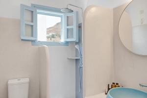 a bathroom with a blue window and a sink at Pico Bello Patmos 28 in Patmos +30 photos