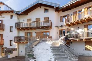 a building with stairs and balconies on it at Appartamento Lory in Cavedago