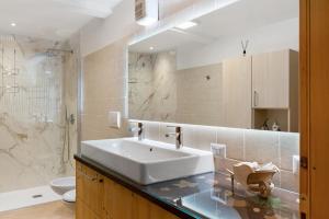 a bathroom with a sink and a toilet at Appartamento Lory in Cavedago