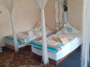 two twin beds in a room with curtains at Ferienhaus Fechter in Lanz