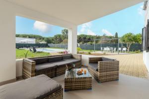 a living room with a couch and chairs and a table at Villa Giovanna in Sorso
