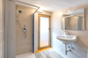 a bathroom with a sink and a mirror and a shower at Villa Giovanna in Sorso +32 photos
