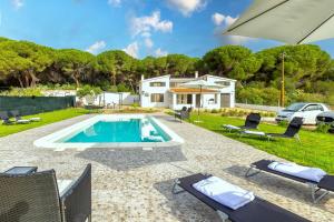 a villa with a swimming pool and a house at Villa Giovanna in Sorso