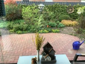 a bird house sitting on a table in a garden at Bohlen Rhede in Rhede