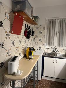a small kitchen with a counter and a sink at Una casa sulla spiaggia in Es Grau