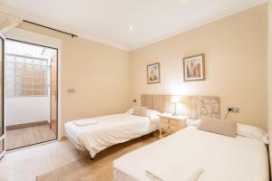 a bedroom with two beds and a window at Unique Patacona in Valencia +37 photos
