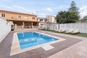 a swimming pool in the backyard of a house at Unique Patacona in Valencia