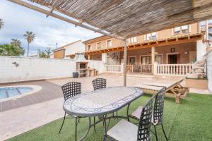 a patio with a table and chairs and a pool at Unique Patacona in Valencia