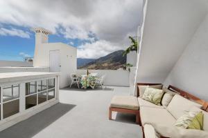 a living room with a couch and a table on a balcony at Vista Alegre 22 A in El Paso