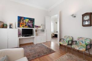 a living room with a tv and two chairs at Vista Alegre 22 A in El Paso