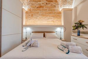 a bedroom with a bed with two flip flops on it at Rosy Maison in Squinzano