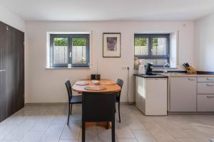 a kitchen with a table and chairs in a room at Ferienwohnung Lago in Konstanz