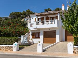 a large white house with a garage at Villa Loes in Menorca