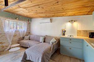 a living room with a couch and a table at Chalet de Ferme - Spa - Gironde in Les Églisottes-et-Chalaures