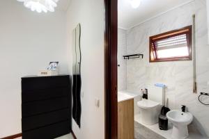 a bathroom with a toilet and a sink at Barrinha Beach in Esmoriz +18 photos