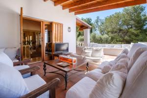 a living room with a couch and a table at Can Bernat in Can Furnet