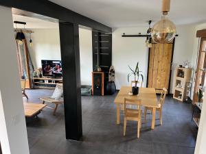 a dining room with a table and chairs in a room at Maison proche dinan au calme in Aucaleuc
