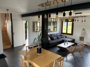 a living room with a table and a couch at Maison proche dinan au calme in Aucaleuc
