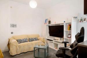 a living room with a couch and a flat screen tv at Piso Leon y Castillo in Arrecife