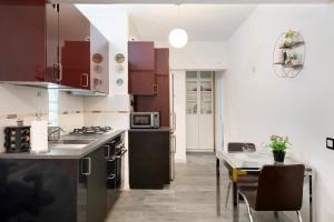 a kitchen with a sink and a table with chairs at Piso Leon y Castillo in Arrecife