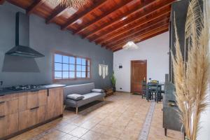 a kitchen and living room with a couch and a table at Retiro Canario in Santa Brígida