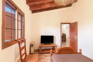 a bedroom with a bed and a television on a table at Retiro Canario in Santa Brígida