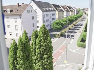 a view of a street with trees and buildings at Fewo Lago di Costanza I in Friedrichshafen