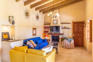 a living room with a blue couch and a fireplace at Son Pou in Sencelles