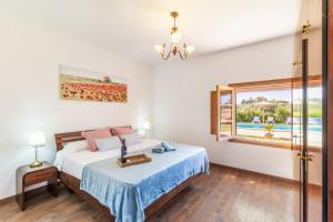 a bedroom with a bed and a window at Son Pou in Sencelles +17 photos