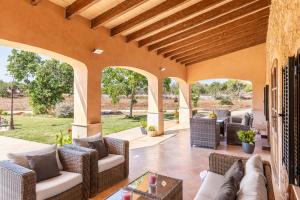 an outdoor patio with wicker chairs and tables at Son Pou in Sencelles