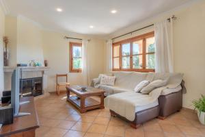 a living room with a couch and a tv at Son Forte Nou in Artá