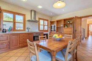 a kitchen with a wooden table with a bowl of fruit on it at Son Forte Nou in Artá