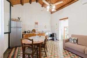 a kitchen and living room with a table and a couch at Da Giovanni A Custonaci in Custonaci