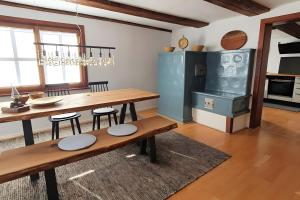 a dining room with a wooden table and chairs at Schatzkästchen am Bodensee in Öhningen