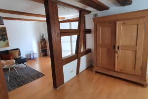 a room with a wooden door and a living room at Schatzkästchen am Bodensee in Öhningen